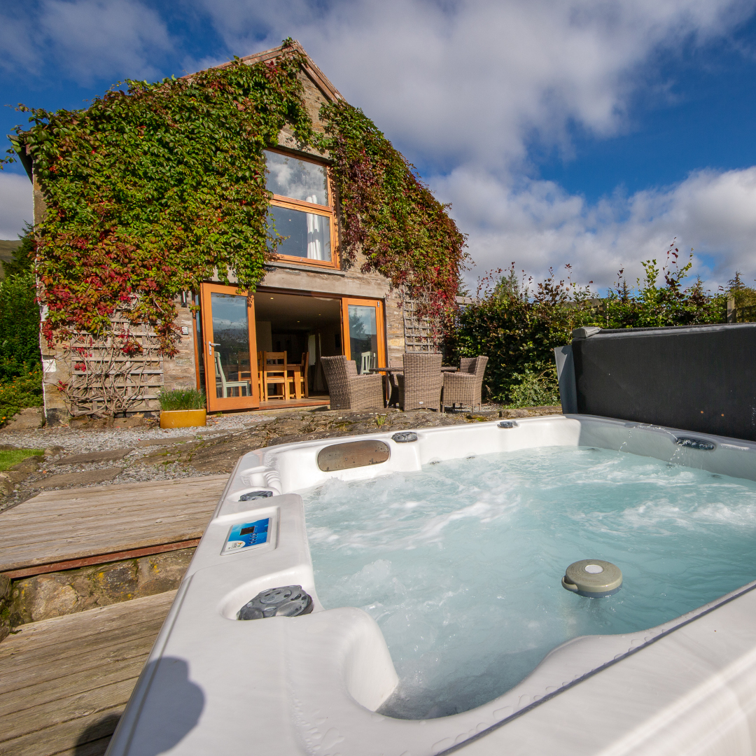Exterior of The Barn at Loch Tay Lodges with private hot tub and garden