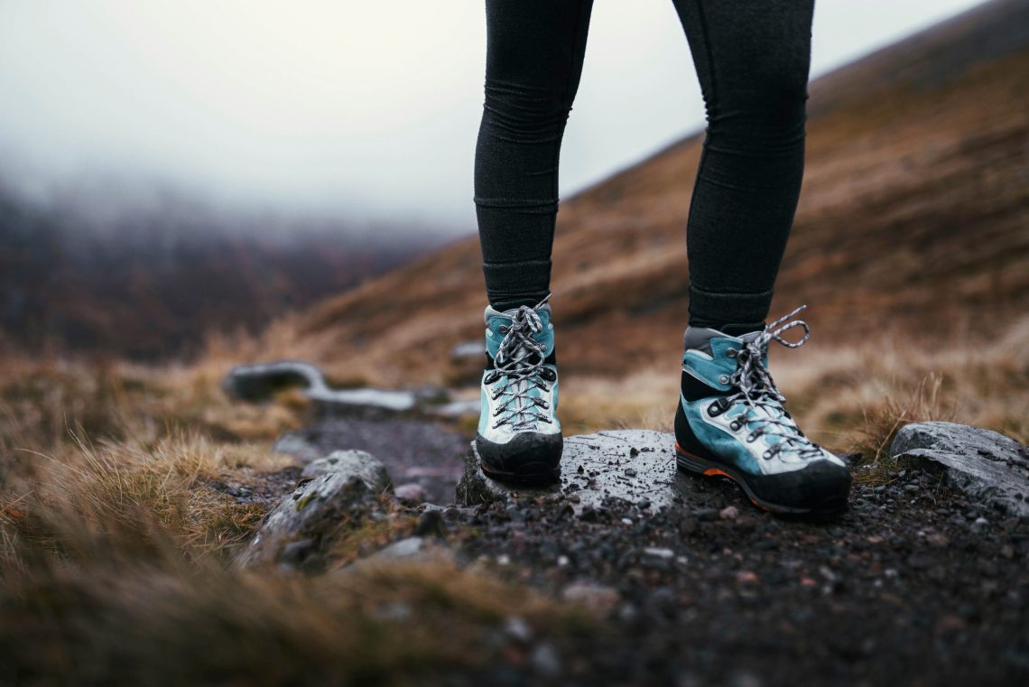 Hiker following a mountain trail in the Scottish Highlands
