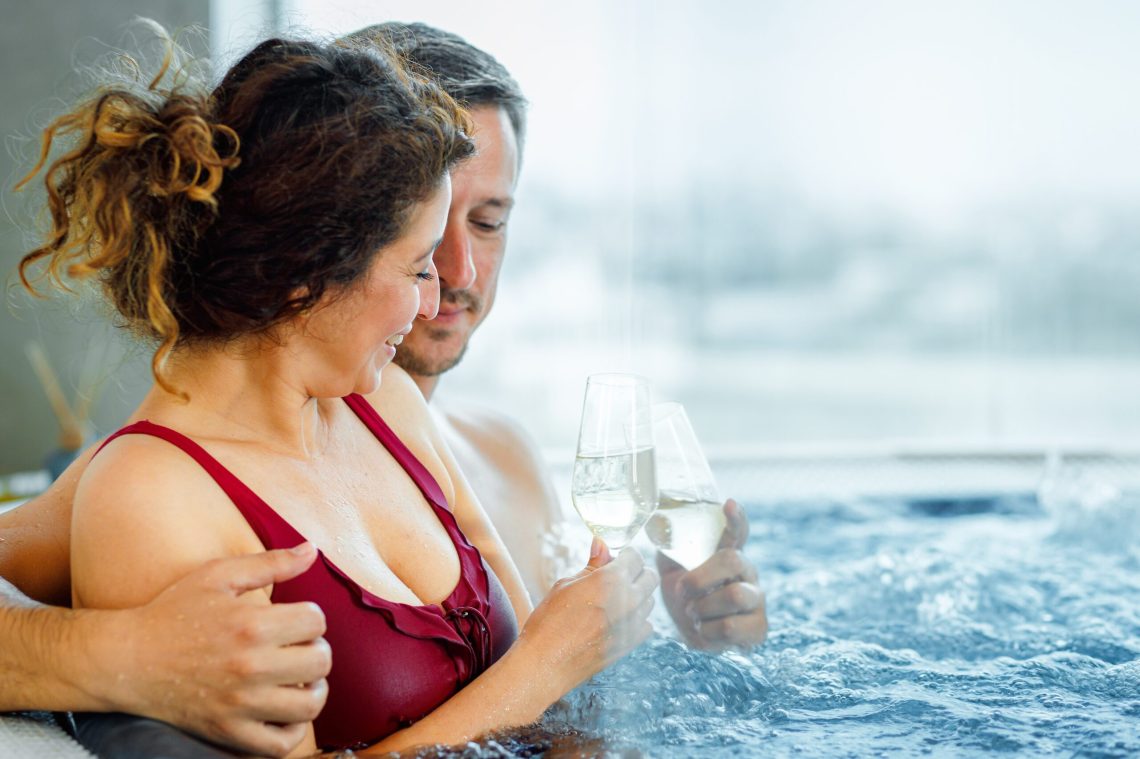 Mature couple relaxing together in a hot tub